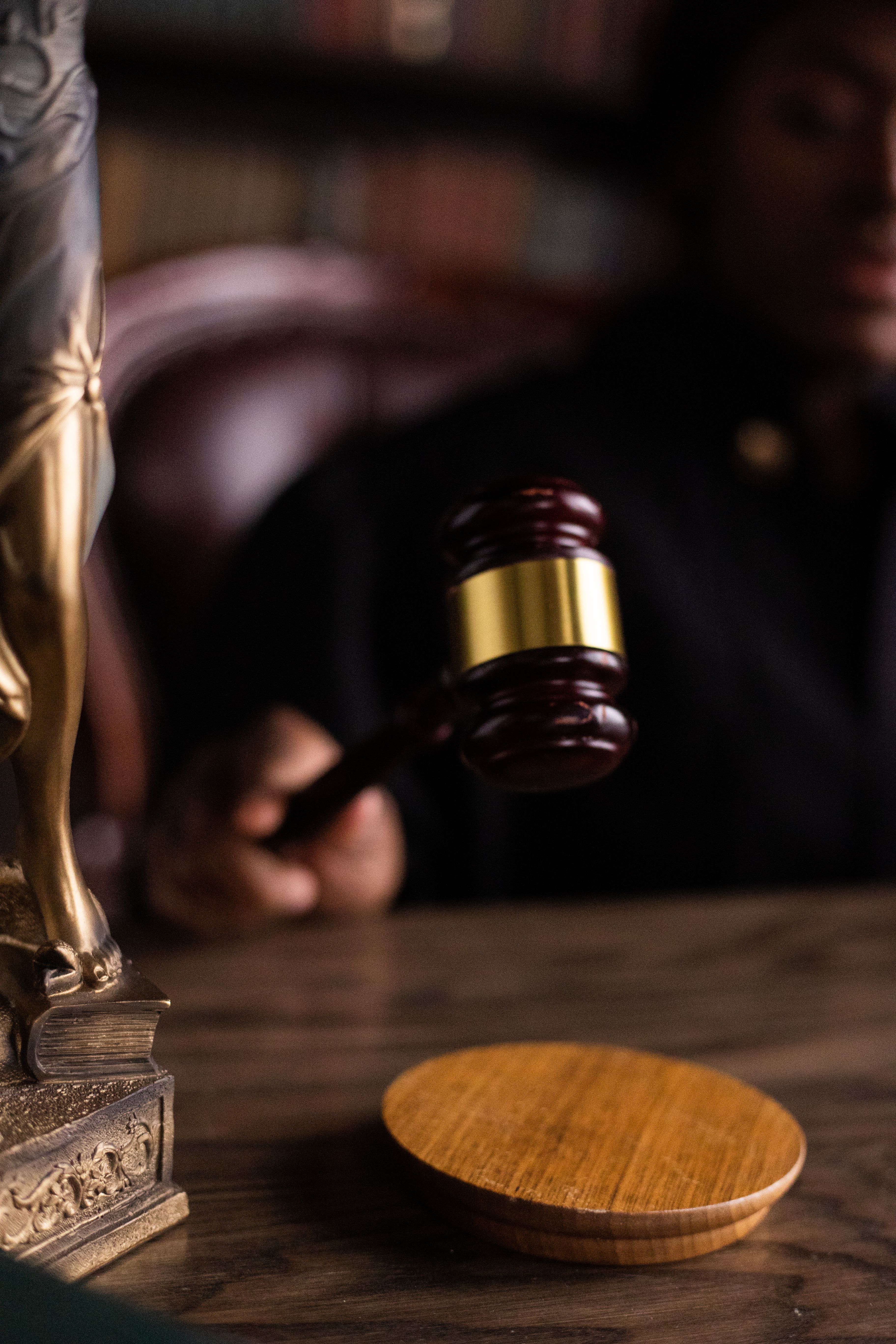 A judge's gavel resting on its sounding block